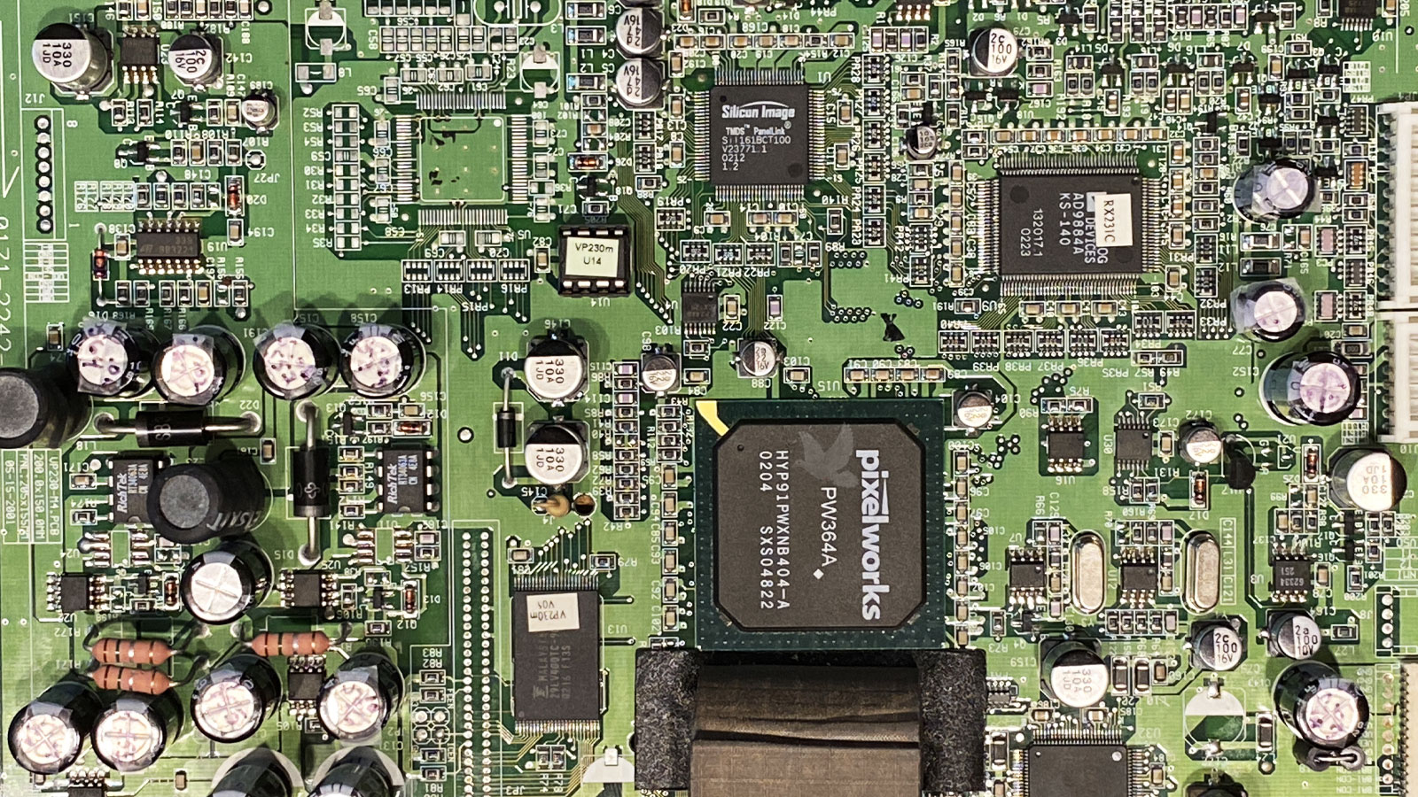 Pixelworks main chip on a circuit board with a damaged U7 IC located nearby, identified and replaced to restore normal operation.