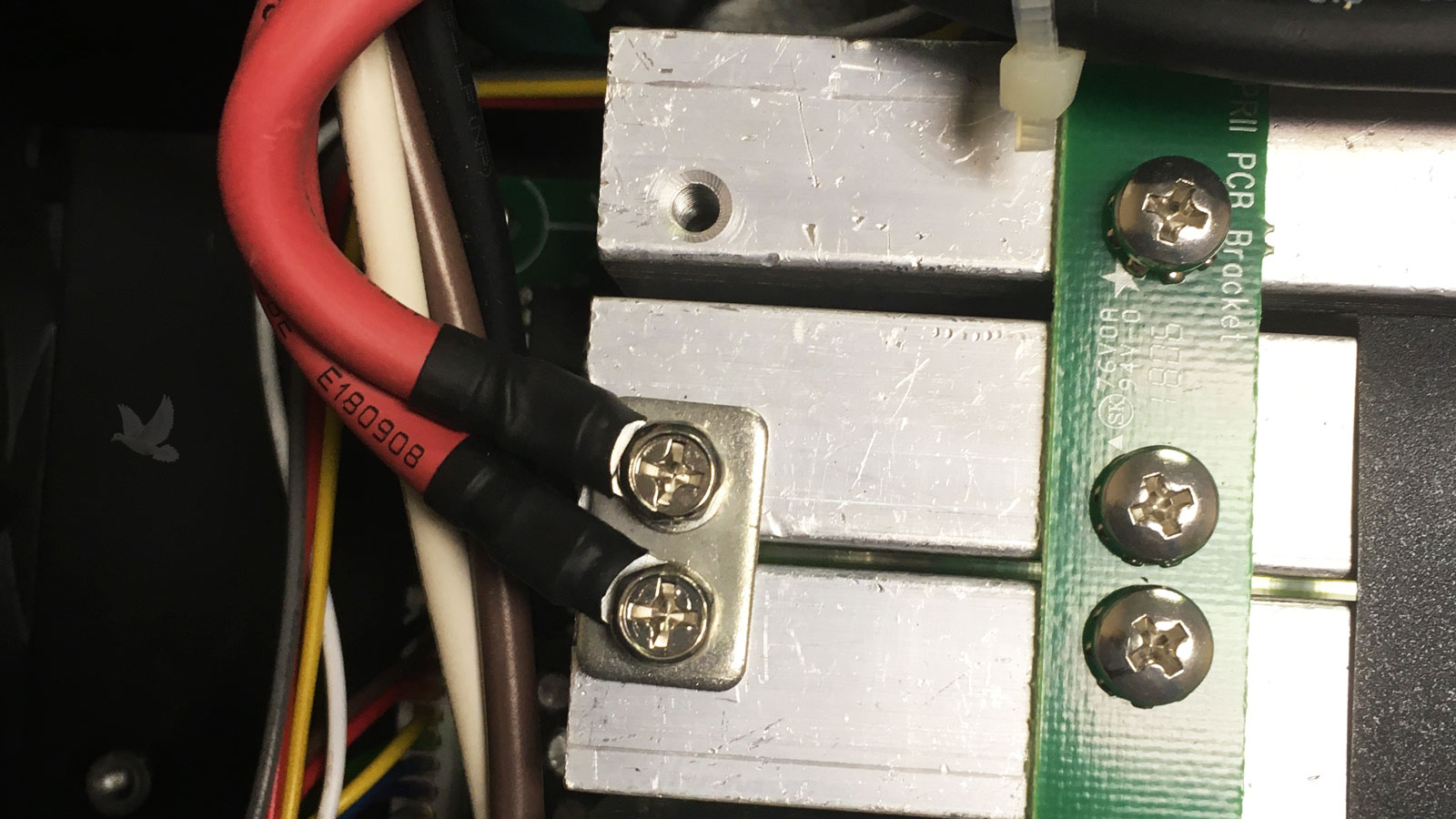 High-power circuit with securely grounded metal sections and bolted red cable connections