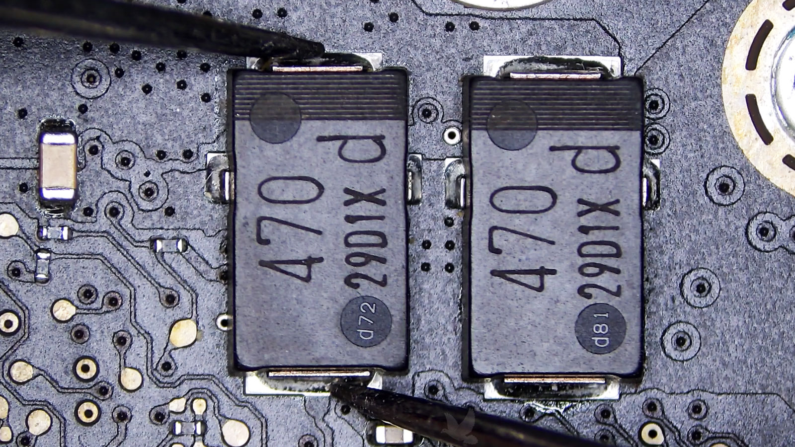 Two parallel SMD capacitors with the left D72 capacitor confirmed internally shorted