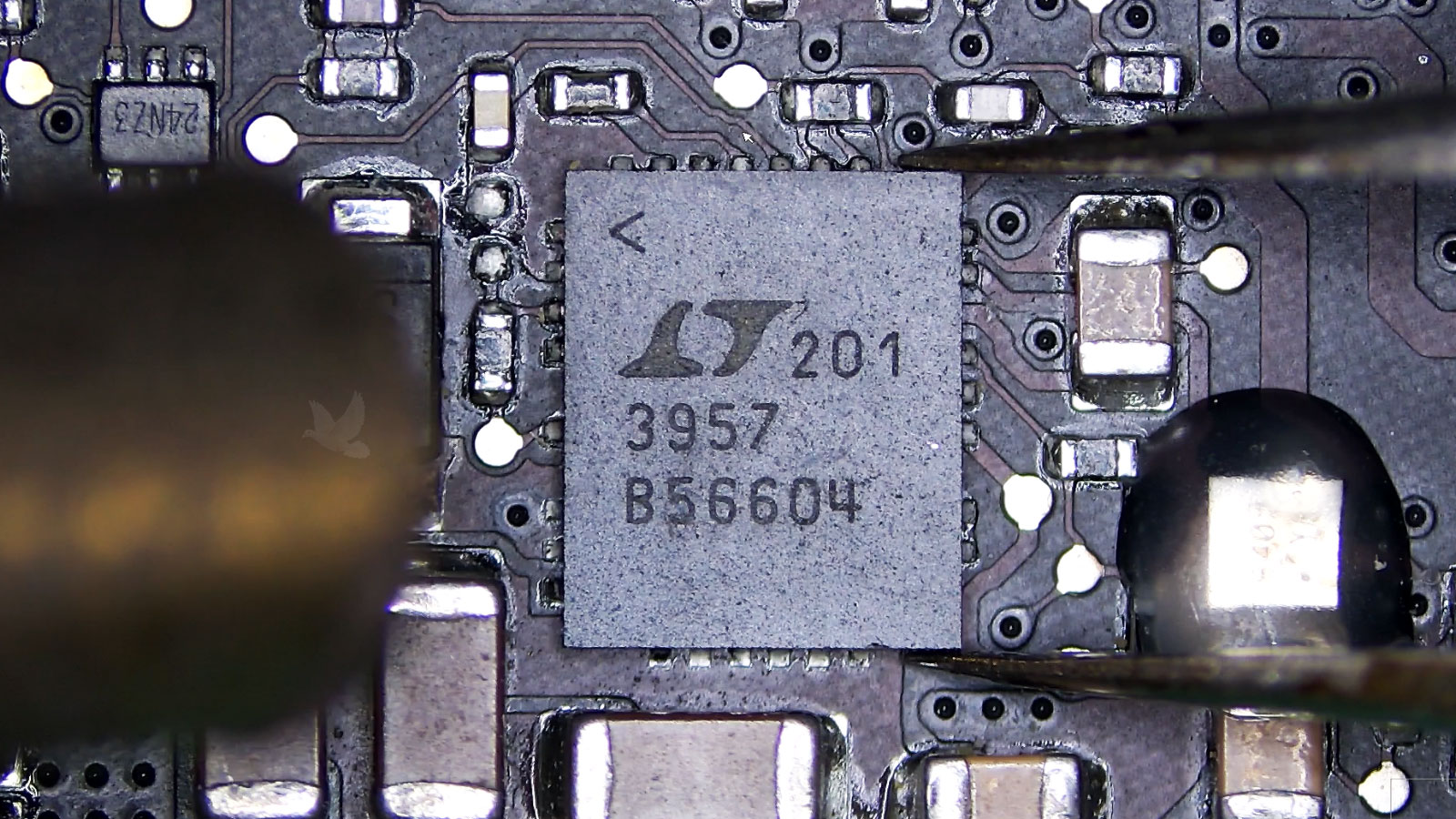 Shorted IC chip being removed from a circuit board with a hot air rework station