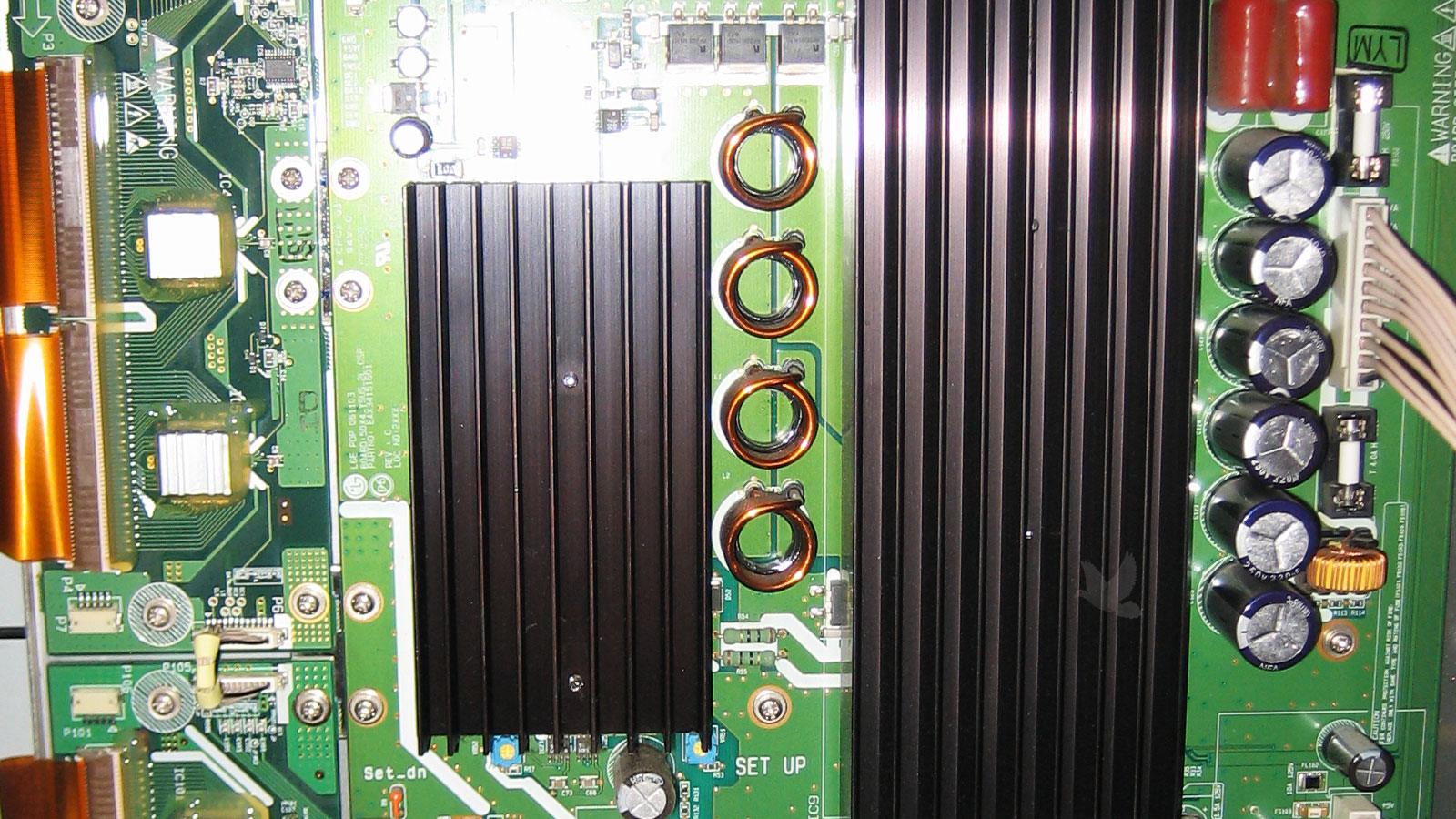 Circuit board with six new capacitors and two replacement fuses installed