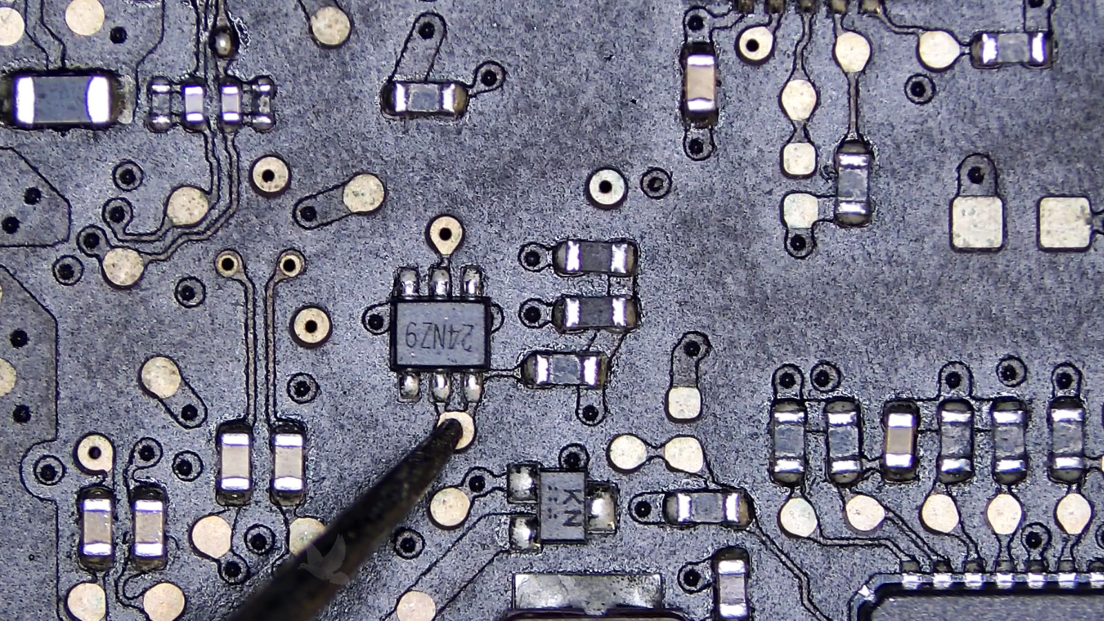 Testing a six-pin IC by measuring two connected circuit board pads
