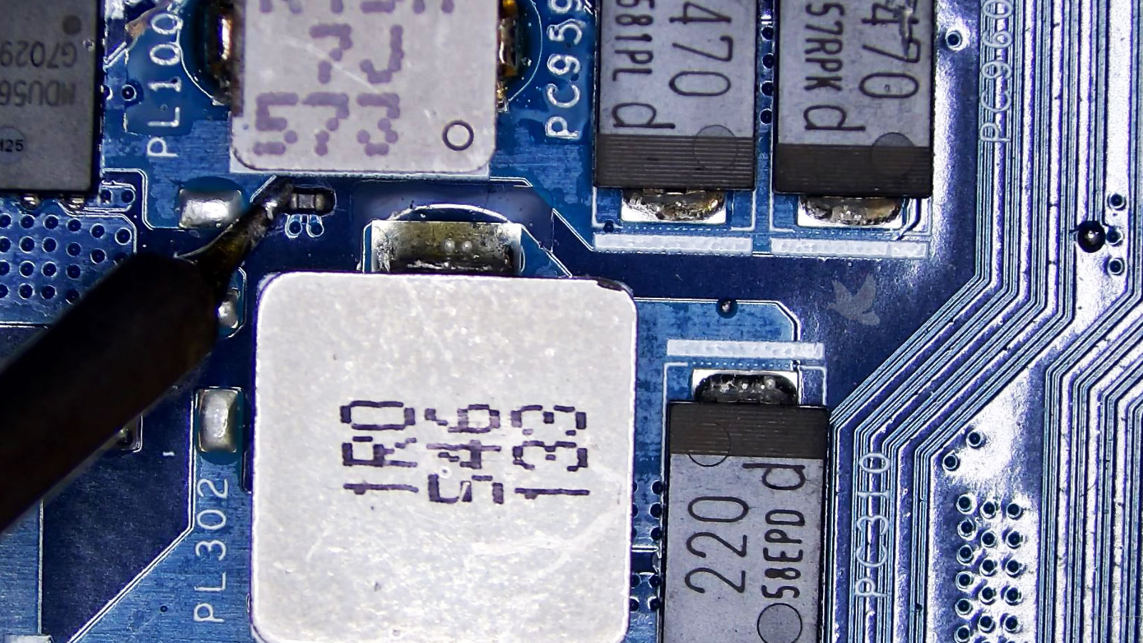 Microsoldering a tiny capacitor positioned in the narrow space between two coils