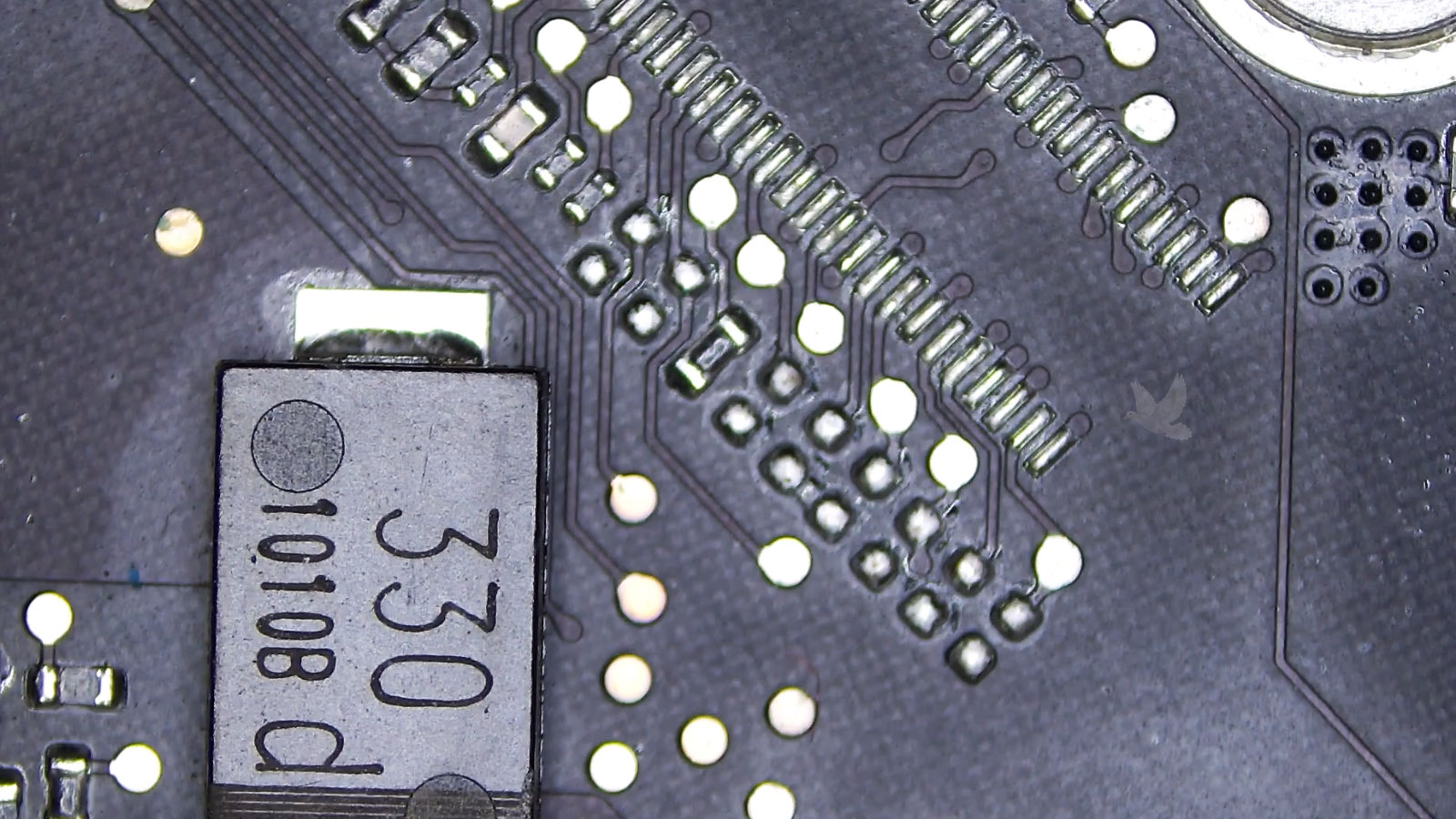 Tiny surface-mount resistor on a circuit board that failed internally and interrupted the circuit