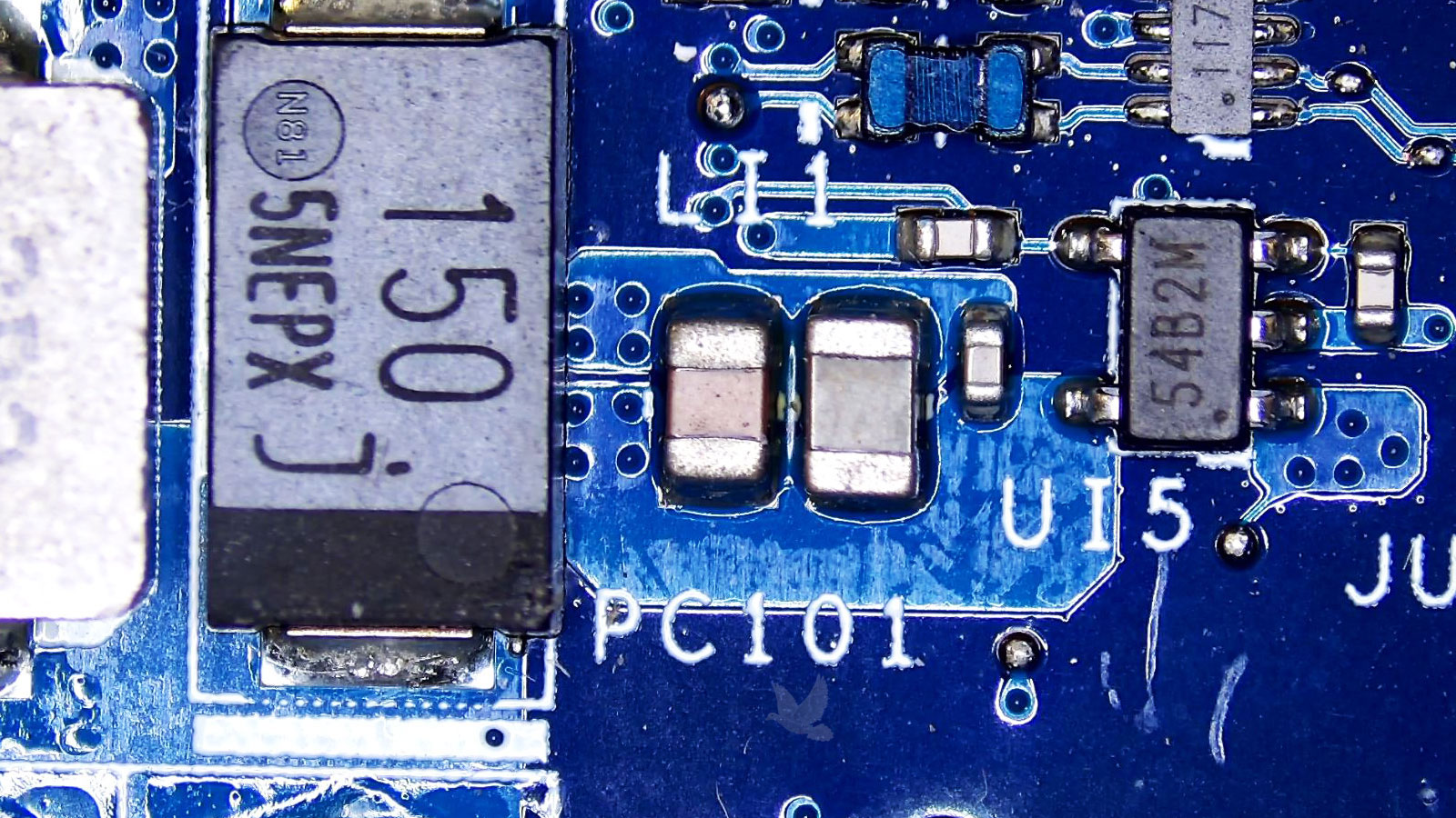 U5 IC chip marked 54B2M being tested with one pin shorted to ground