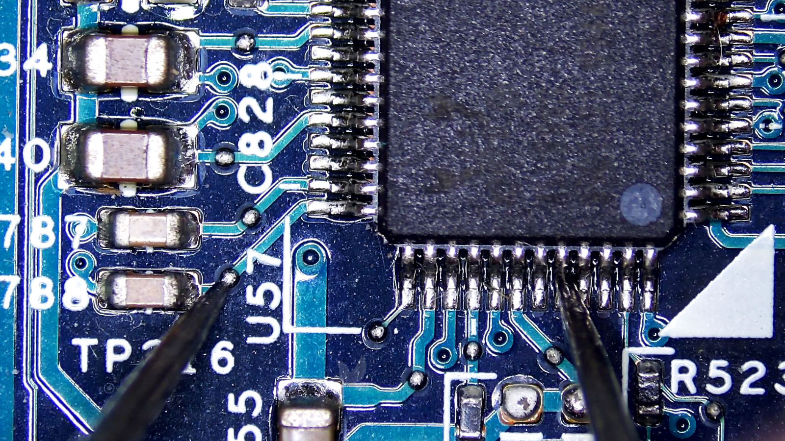 U57 IC chip being tested between capacitor 788 and an opposite pin with no continuity detected