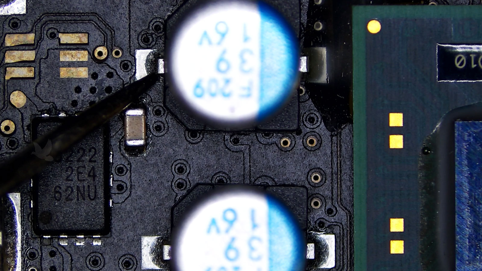 Measuring one terminal of a 16-volt F 209 39 capacitor next to the GPU with unstable readings