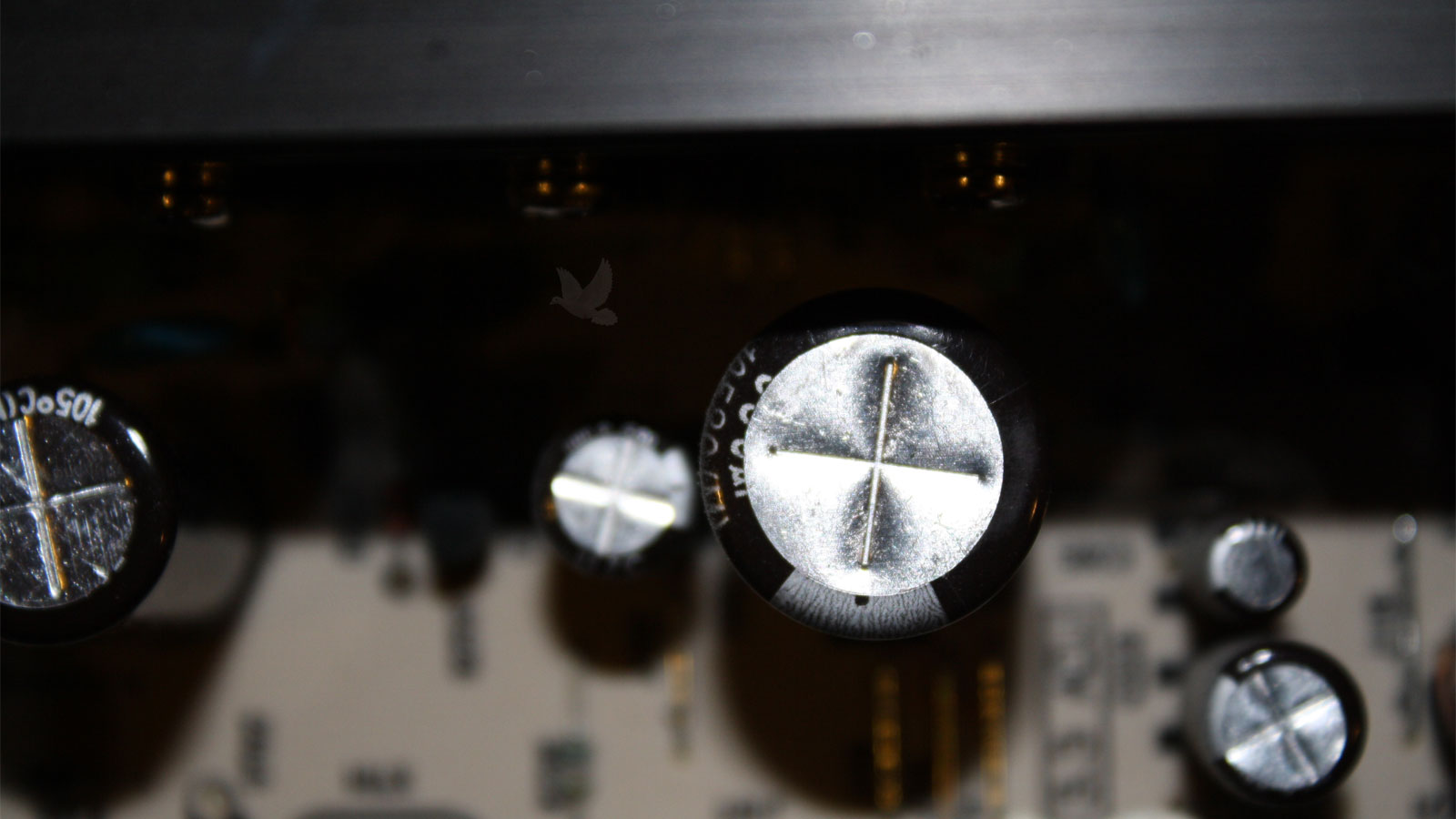 Circuit board capacitors visually inspected for bulging or swollen tops