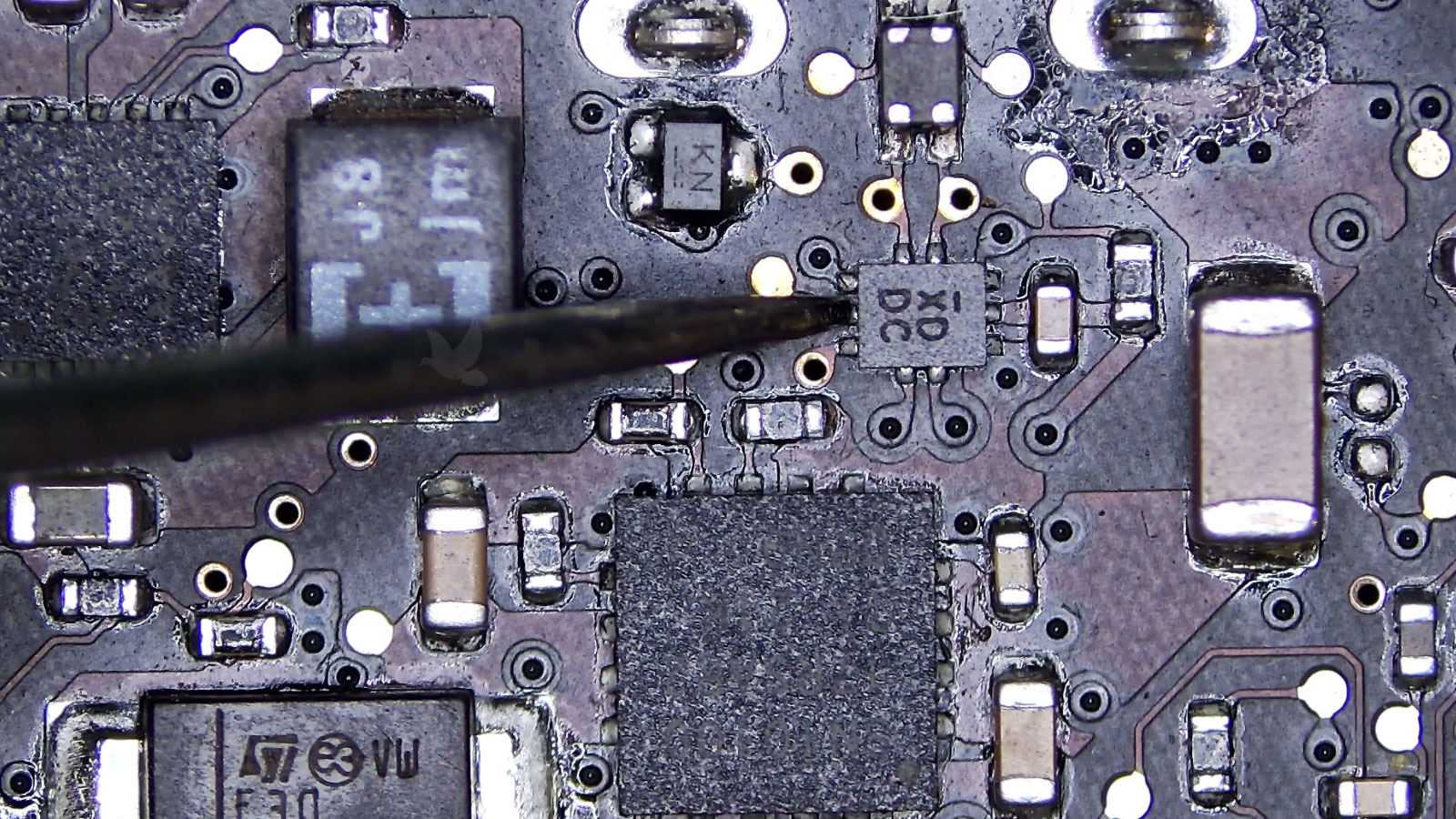 XDDC chip center pin being measured for missing voltage on a computer circuit board